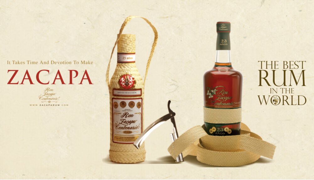 Ron Zacapa Centenario 23 A&ntilde;os beside its woven palm-leaf gift bottle, under the lines &lsquo;It Takes Time And Devotion To Make Zacapa&rsquo; and &lsquo;The Best Rum In The World&rsquo;.